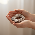 Сребристо копринено скрънче в дланите